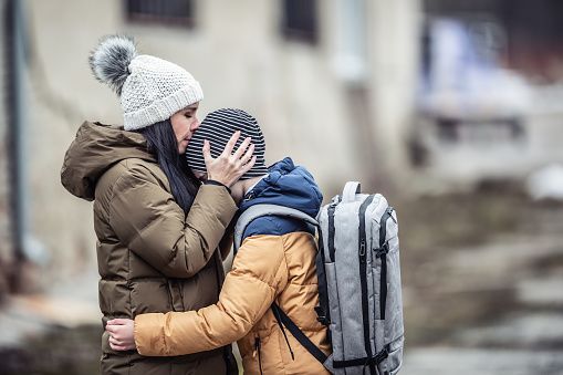 Woman kisses her little boy